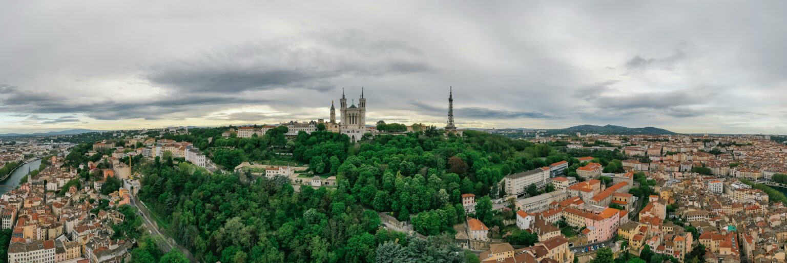 A breathtaking aerial panoramic view of Lyon with the Basilica and cityscape.